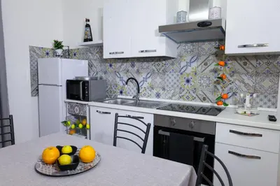 a kitchen with a table with a bowl of fruit on it at Afrodite appartamento Ballarò in Palermo
