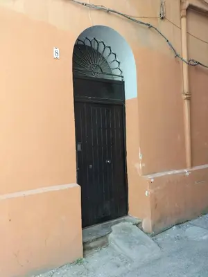 a black door in the side of a building at Afrodite appartamento Ballarò in Palermo