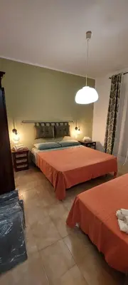a large bedroom with two beds and a light at Villa Summer in Trappeto