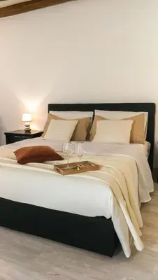 a large bed with two wine glasses on it at Cesare Home in Palermo