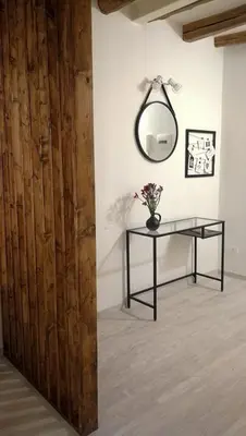 a room with a table and a mirror on the wall at Cesare Home in Palermo
