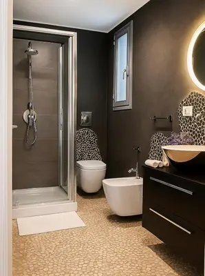 a bathroom with a shower and a toilet and a sink at Cesare Home in Palermo
