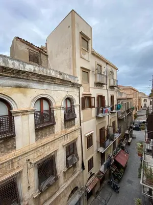 an alley between two buildings with balconies at Appartamenti Maria Al Capo in Palermo