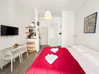 a bedroom with a red blanket on a bed at Appartamenti Maria Al Capo in Palermo