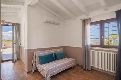a bedroom with a bed with blue pillows on it at Meravigliosa Villa a Trappeto vicino al mare in Trappeto