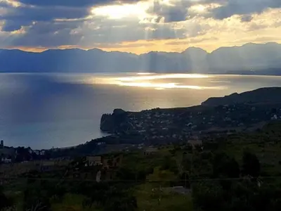 a view of a body of water with the sun setting at Villa with Pool, Pets & WiFi in Misilmeri
