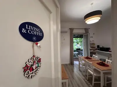 a living and coffee sign on a wall in a room at Carpe Diem Rooms by Marino Tourist in Palermo