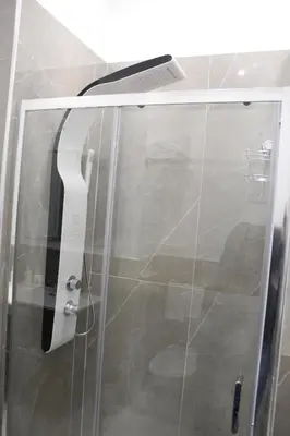 a glass door of a shower in a bathroom at Carpe Diem Rooms by Marino Tourist in Palermo