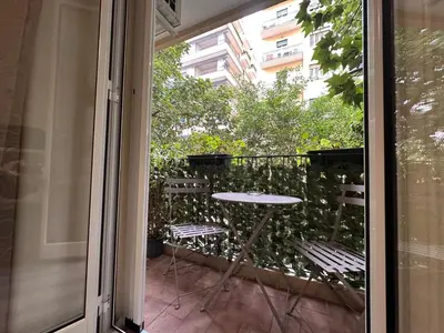 a patio with a table and chairs on a balcony at Carpe Diem Rooms by Marino Tourist in Palermo