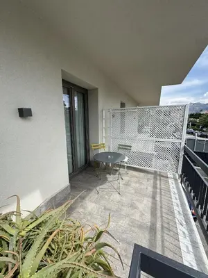 a balcony with a table and chairs on a building at Solus b&b in Casteldaccia
