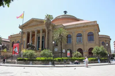 a large building with a statue in front of it at B&B Liberty in Palermo