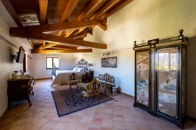 a large room with a bed and a room with at Villa del Gattopardo in Palermo