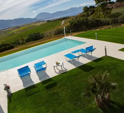 an overhead view of a swimming pool with chairs and a table at Case Playa Resort Balestrate in Balestrate