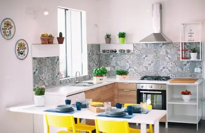 a kitchen with yellow chairs and a table and a sink at Case Playa Resort Balestrate in Balestrate