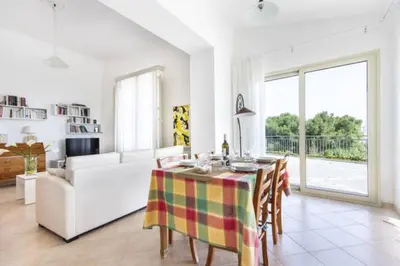 a living room with a table and a couch at villa Sun in Alcamo