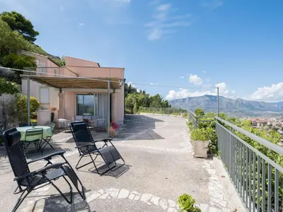 a patio with chairs and a table with a view at villa Sun in Alcamo