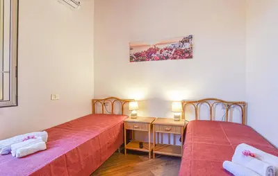 two beds sitting next to each other in a room at Villa Trappeto in Trappeto