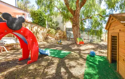 a childrens playground with a large red elephant statue at Villa Trappeto in Trappeto