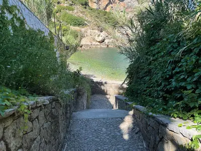 a stone path next to a body of water at Deliziosa Villa a 500 metri dal mare con Piscina in Terrasini