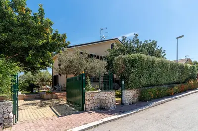 a house with a fence in front of it at Deliziosa Villa a 500 metri dal mare con Piscina in Terrasini