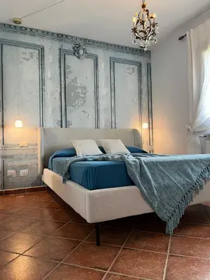 a bedroom with a bed with a blue blanket on it at Deliziosa Villa a 500 metri dal mare con Piscina in Terrasini