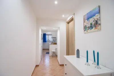 a kitchen with a white counter with green candles on it at Ncantu home in Palermo