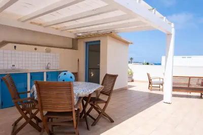 a kitchen and dining room with a table and chairs at Casa Greta a due passi dal mare in San Vito lo Capo