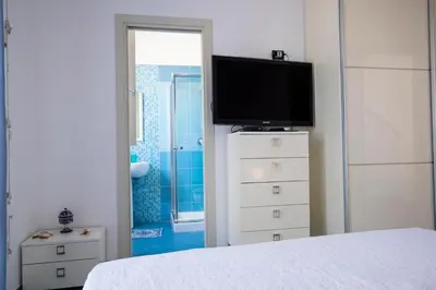 a bedroom with a television on top of a dresser at Casa Greta a due passi dal mare in San Vito lo Capo