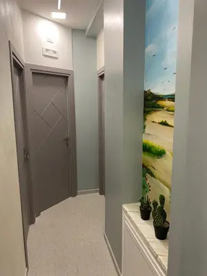 a hallway with a door and a painting on the wall at Palermo City Room in Palermo