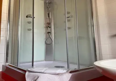 a shower with a glass door next to a sink at Franco Il Conte in Bagheria