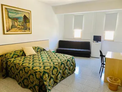 a hotel room with a bed and a couch at Franco Il Conte in Bagheria
