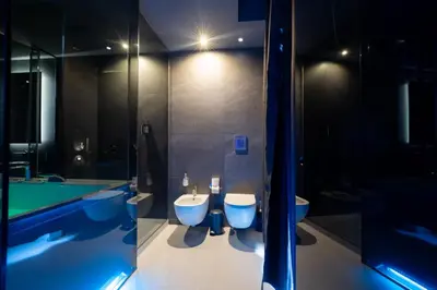 a bathroom with two toilets and a bath tub at Maximum Suite & Spa in Palermo
