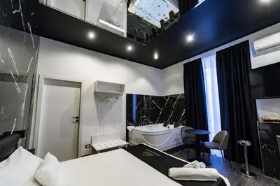 a bedroom with a bed and a tub and a sink at Maximum Suite & Spa in Palermo