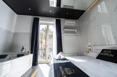 a bedroom with a large bed and a window at Maximum Suite & Spa in Palermo