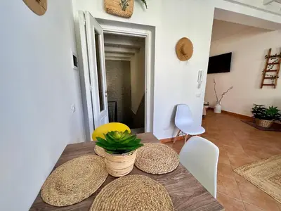 a dining room with a wooden table and chairs at da Mumminedda in Cinisi