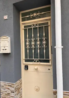 a front door of a house with a gate at da Mumminedda in Cinisi