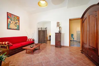 a living room with a red couch and a table at Apartment, Castellammare del Golfo in Castellammare del Golfo