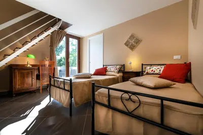 a bedroom with two beds and a piano at Villa San Lorenzo in Palermo