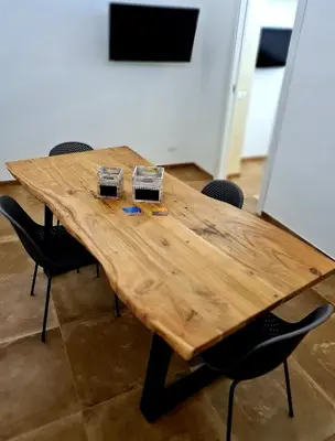 a wooden table in a room with chairs around it at SCRUSCIU HOME in Terrasini