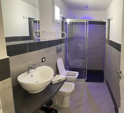 a bathroom with a sink and a toilet and a shower at LA CASA DELLE FATE-Area Marina Protetta in Isola delle Femmine