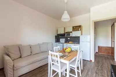 a living room with a couch and a table and chairs at Mondello Sabrina Apartments in Mondello