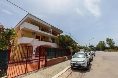a car parked in front of a house at Mondello Sabrina Apartments in Mondello