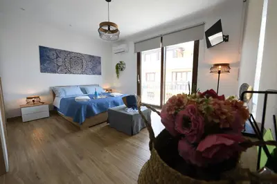 a living room with a bed and a living room with at Terra Sinus Beautiful Suite in Terrasini