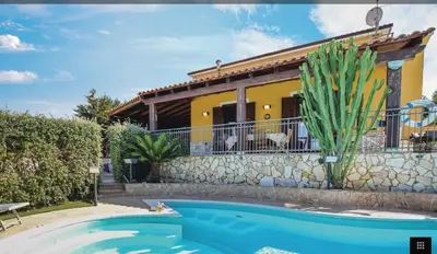 a villa with a swimming pool in front of a house at Villa indipendente in Altavilla Milicia