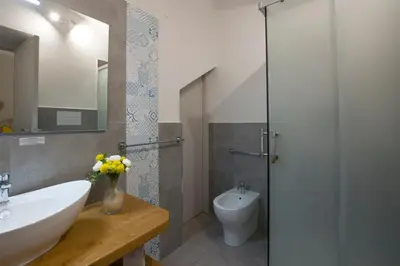 a bathroom with a sink and a toilet at Capo Rama Suites & Rooms in Terrasini