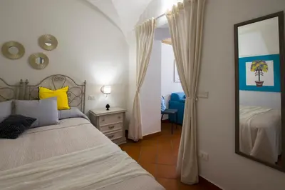 a bedroom with a bed and a mirror at Capo Rama Suites & Rooms in Terrasini