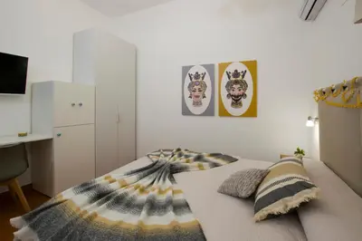 a bedroom with a bed with a blanket on it at Capo Rama Suites & Rooms in Terrasini