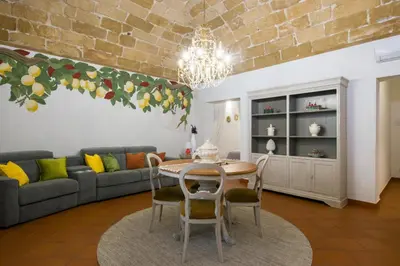 a living room with a table and a couch at Capo Rama Suites & Rooms in Terrasini
