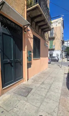 a building with a door on the side of a street at Casetta Delia in Palermo