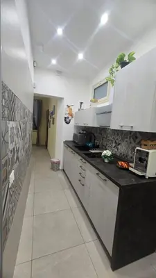 a kitchen with a counter with a laptop on it at Casetta Delia in Palermo